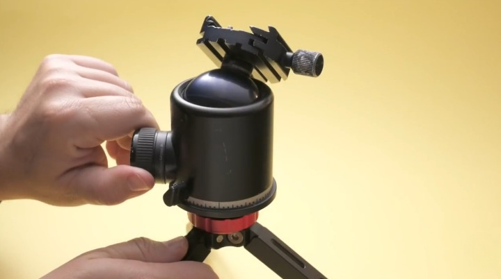 Une main reglant la molette de friction laterale dune rotule ball 3